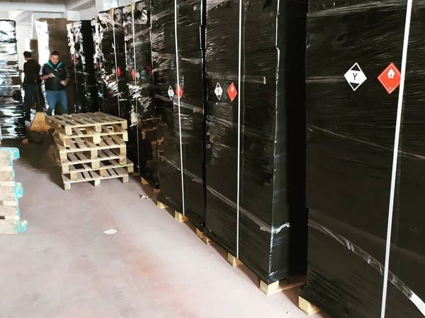 Siyah streç film ve çemberle sabitlenmiş tehlikeli madde paletleri